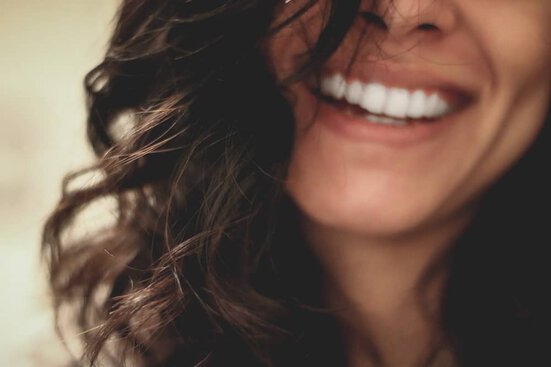 smiling to raise vibration close up of woman smiling