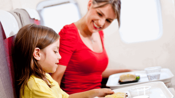 mother and child on plane eating food