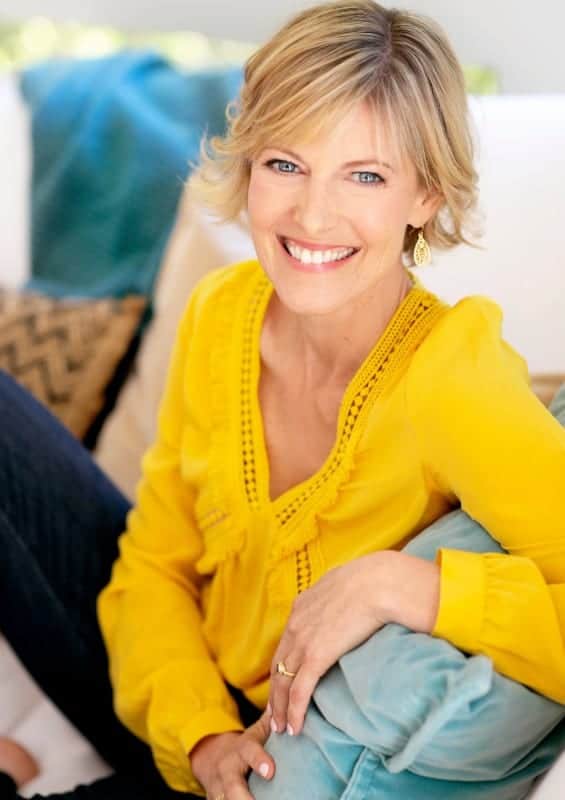 Elizabeth Hunter Diamond, psychic energy healer sits on white couch.