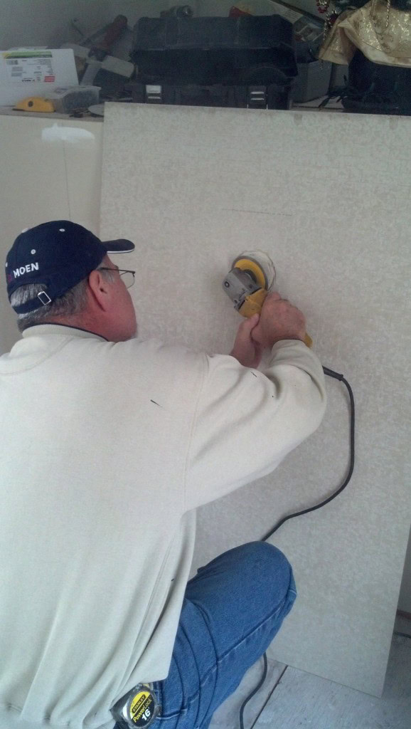 Dad did most of the heavy lifting as I was SUPER sore having finally stopped taking my pain pills from breaking my back three months ago. I have pretty much been worthless but I am happy to finally be getting my wits back about me. It's amazing how cloudy that stuff makes you feel! Here dad is using the grinder to cut out the opening for the ceiling light.