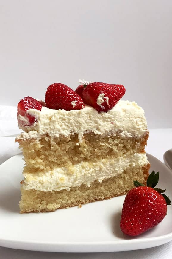 A Slice of Strawberry Layer Cake Filled with Whipped Cream