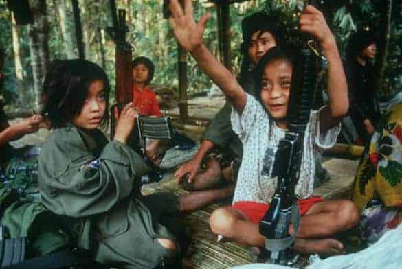 Young girls child soldiers holding rifles
