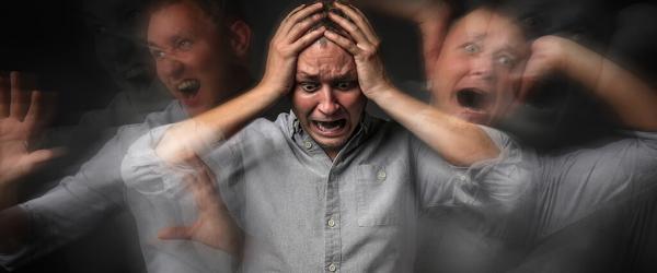 Man having panic attack on dark background Man having panic attack on dark background