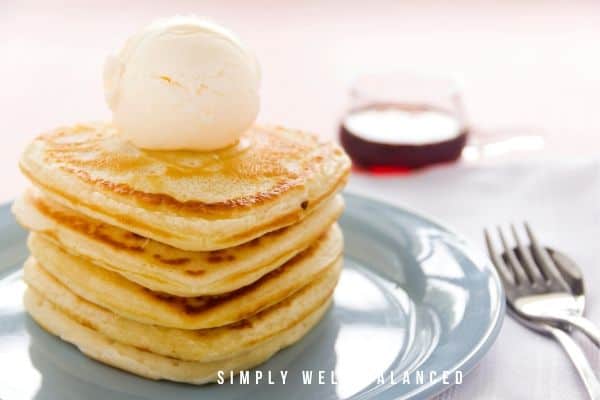 Family Valentine's Day breakfast - heart shaped pancakes on a blue plate.