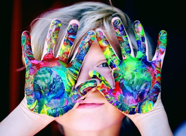 what is sensory processing disorder spd boy with coloured paint on hands text what is sensory processing disorder