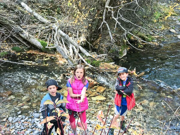 3 kids playing by water