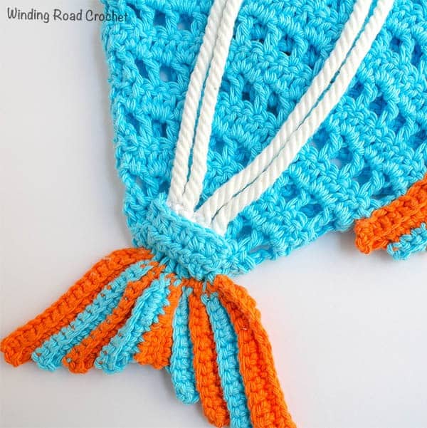 The Fish Beach Backpack is the kids way to help drag all the beach toys to the pool with their own crochet beach bag. This free crochet pattern has photos to walk your through the whole project. #crochet #beachbag #freepattern