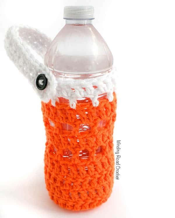 On the Go Water Carrier | Beat the summer heat and never be without water when you make on of these quick and easy water bottle carriers. This free crochet pattern is great for beginners, people with not a lot of time to crochet, anyone with a little extra yarn from a project or anyone who drinks water. Make a crochet water bottle carrier for everyone in your family before your next family outing. This bottle carrier can be fastened to a backpack, purse or stroller. #freecrochetpattern #free #crochet #pattern #waterbottle #beattheheat #watercarrier #bottleholder #hiking #stroller