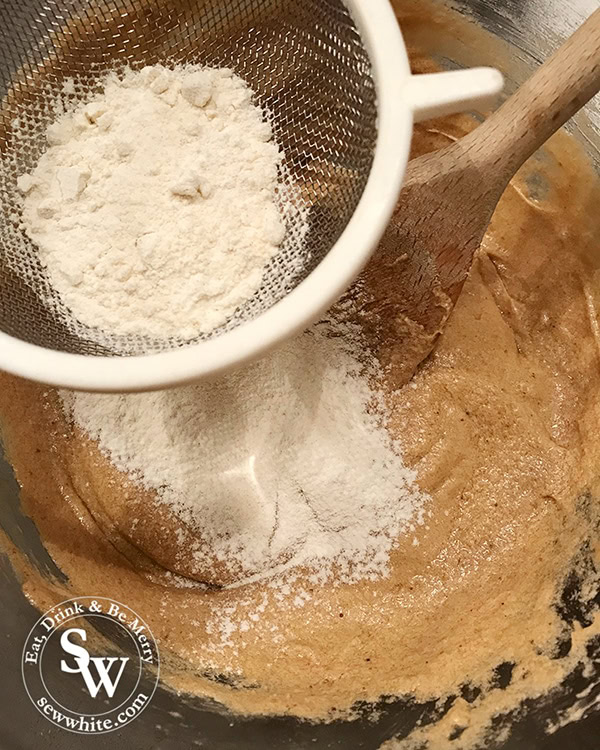 Sieve the flour into the cookie mixture.