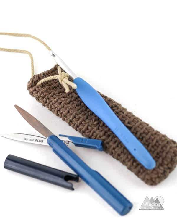 Free crochet pattern for a hook pouch necklace that can be worked up quick and easy. This is great project for beginners and make a beautiful bohemian inspired pouch necklace that is perfect for keeping your crochet hooks safe. #crochetpattern #crochetnecklace #quickcrochet