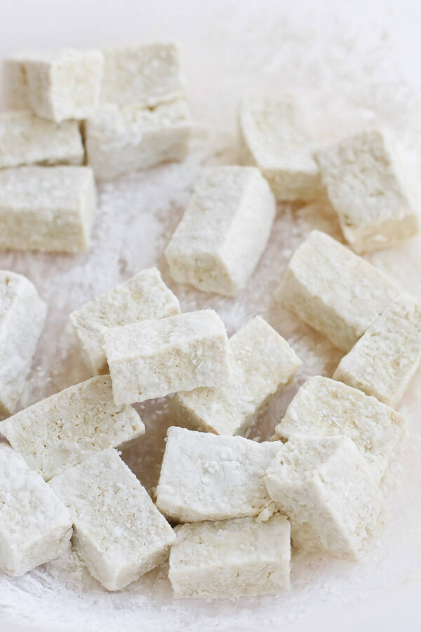 Instant Pot Tofu - TIDBITS Marci Close up of pressure cooker tofu pieces on a white background