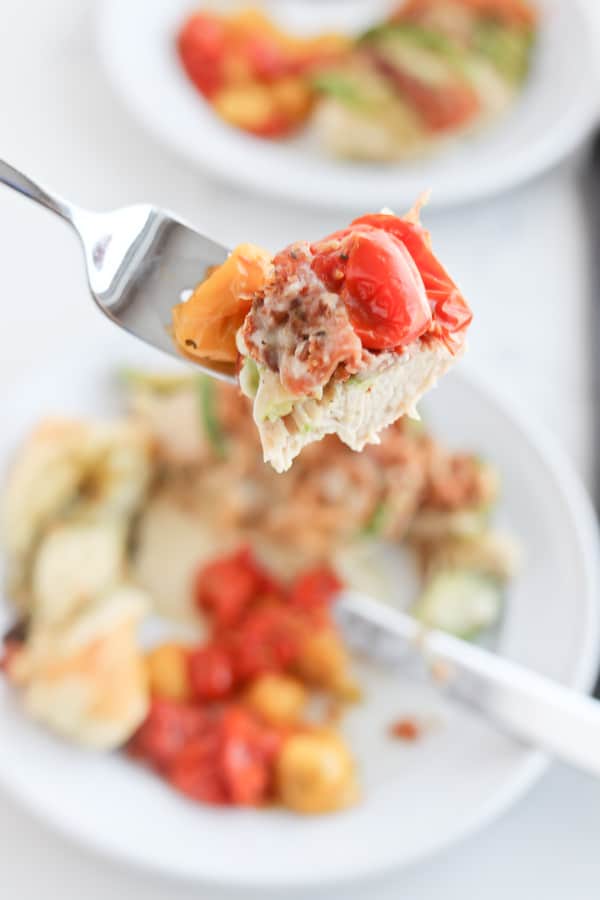 Fork with food being held towards camera