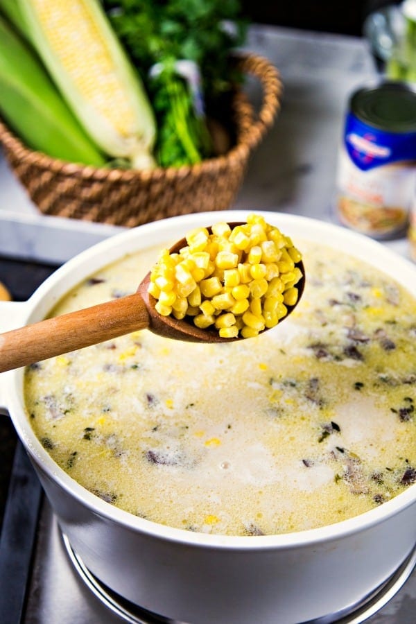 adding corn to chowder