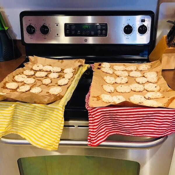 Bake Coconut Kiss Cookies on brown paper because there's a trick to loosening them! Put the whole sheet over a wet towel. The moisture loosens the cookie.