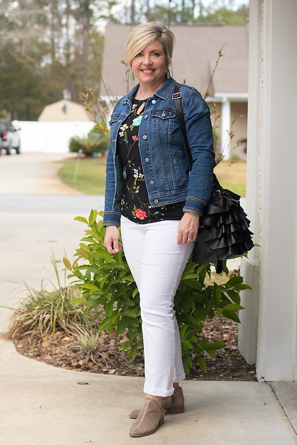 denim jacket with black floral top and white jeans