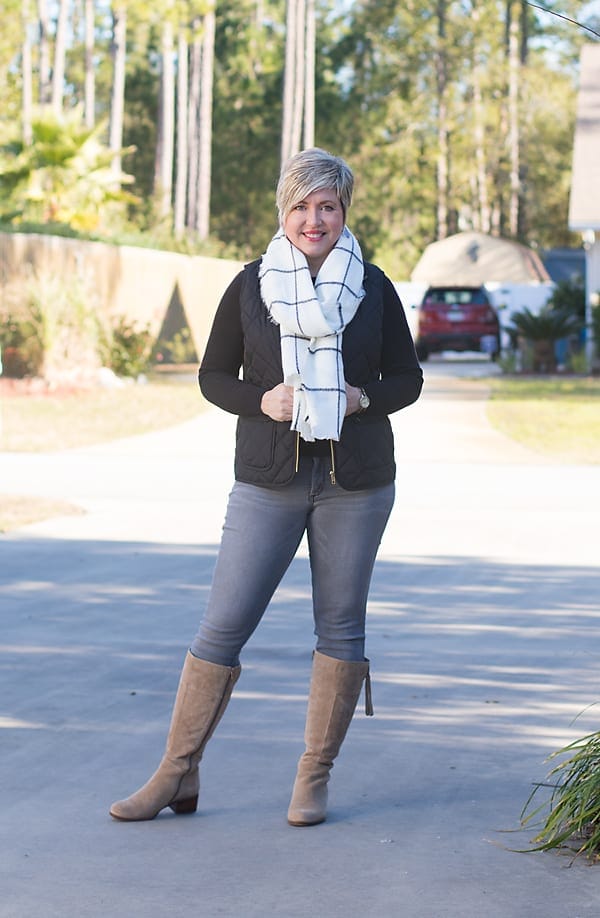 grey jeans with black quilted vest
