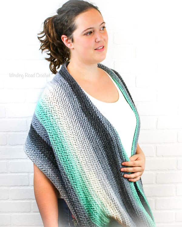 The Herringbone Infintiy Shawl is a great crochet shawl to carry with you. This free crochet pattern is great for beginners that are ready to try a new stitch. I have a herringbone crochet stitch photo tutorial. The texture in this shawl is very unique and the shawl can be worn like a thick infinity scarf. #crochet #crochetpattern #forbeginners #easy #shawl #crochetshawl #infinityscarf