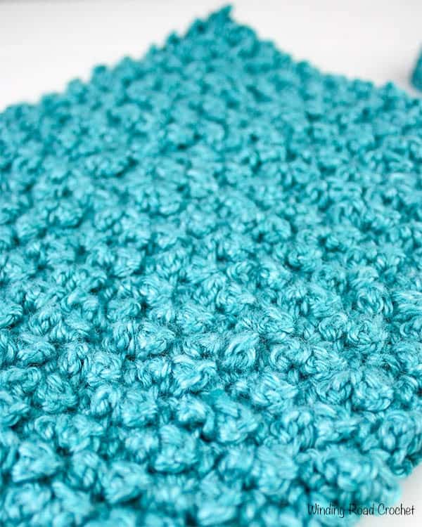 If you are looking for a beautiful rustic crochet textured stitch look no further than the mini berry stitch! This crochet stitch video tutorial will show you how to crochet this beautiful stitch. Plus I have a hat pattern you can make using this stitch.