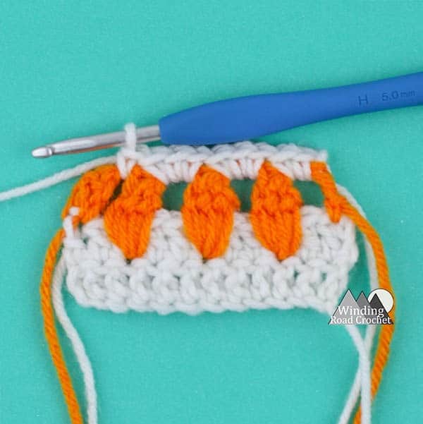 Learn to make the garden inspired carrot crochet stitch with this video tutorial. This is a great stitch to add some spring detail to any crochet project.
