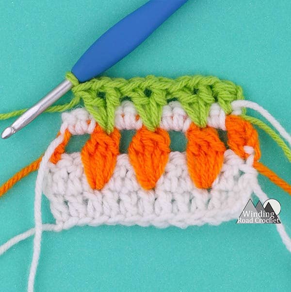 Learn to make the garden inspired carrot crochet stitch with this video tutorial. This is a great stitch to add some spring detail to any crochet project.