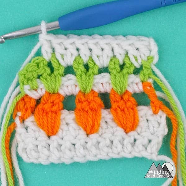 Learn to make the garden inspired carrot crochet stitch with this video tutorial. This is a great stitch to add some spring detail to any crochet project.