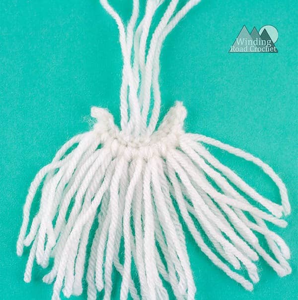 Crochet a cute amigurumi gnome with this free crochet pattern. The garden gnome is a perfect spring project and works up quick. Using only basic stitches this garden gnome is an easy project. Crochet one to watch over your garden. #crochetgnome #amigurumicrochet #springcrochet