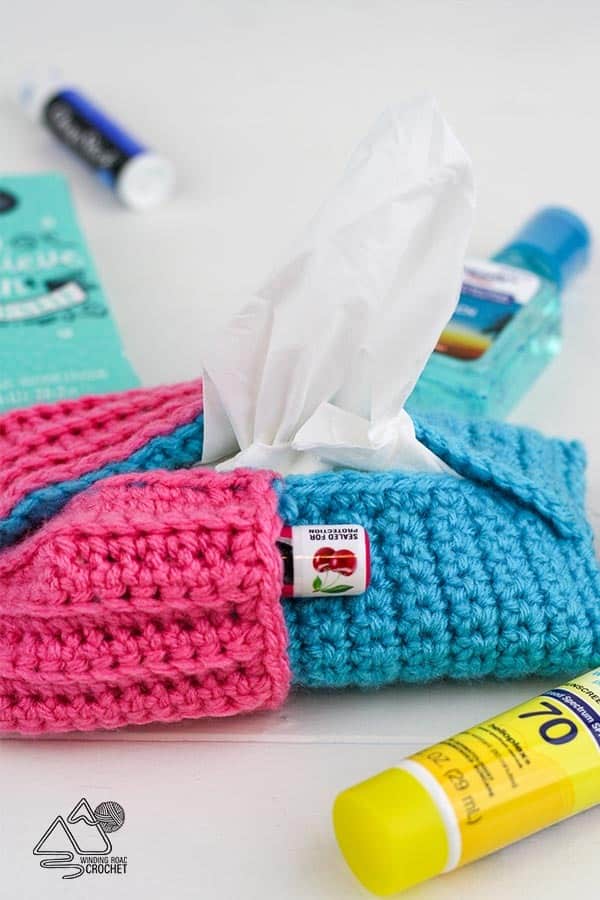 Make a quick and easy crochet tissue pouch with pocket. This free pattern for beginners make a perfect pouch for purses, bags, backpacks and more. #crochetpouch #crochetpattern