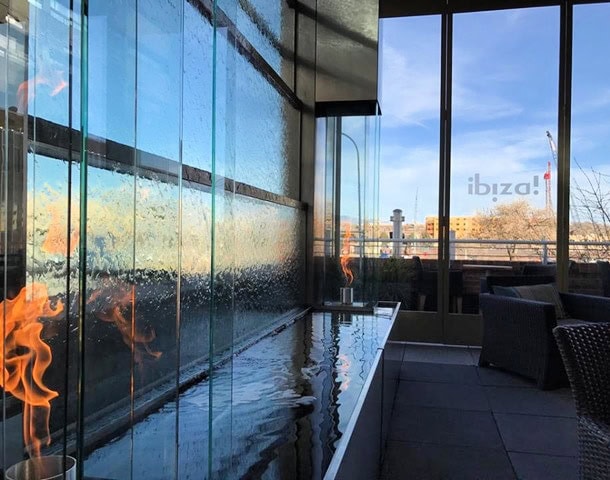 Gas flames decorate water feature on rooftop bar