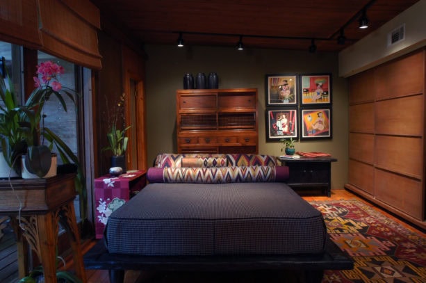 flat natural reed roman shade in a cozy unisex bedroom