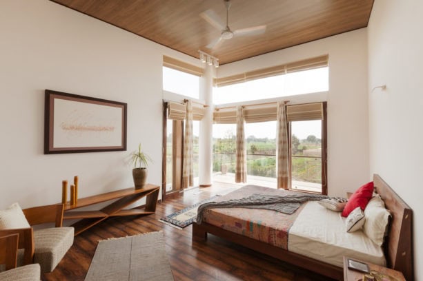 light-color hobbled reed roman shade in a contemporary bedroom