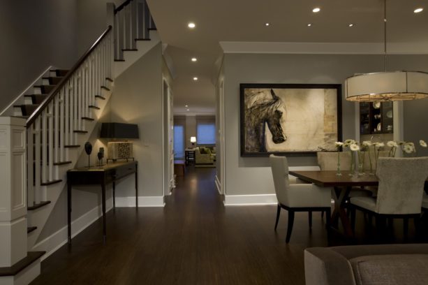 a traditional dining room with dark-stained bamboo wood floor and shite trim