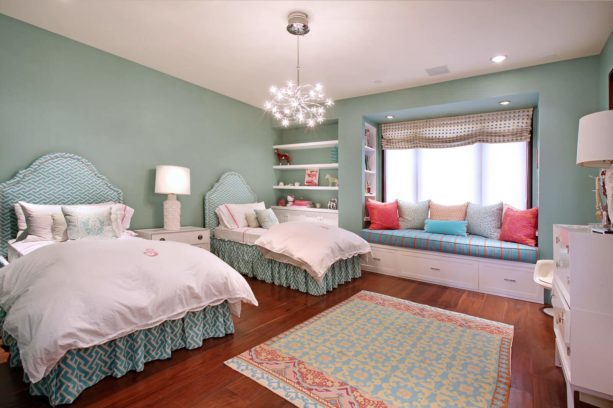 a delicate contemporary bedroom with greyish blue tone and coral accents