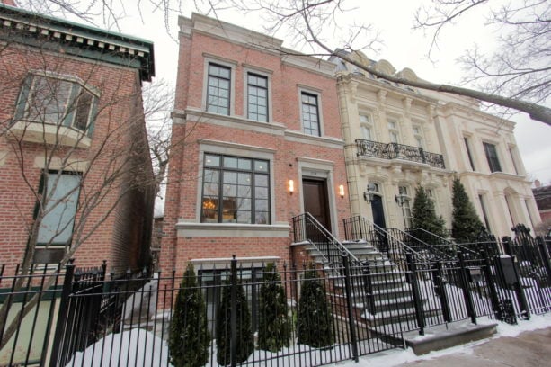 a row house with red brick exterior with beige trims
