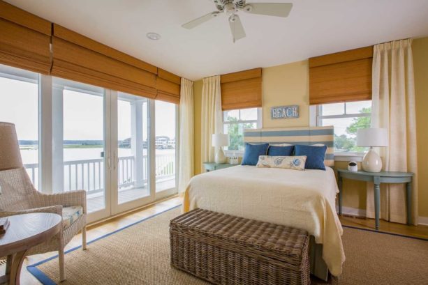 brown woven fabric flat roman shade in a beach-style bedroom