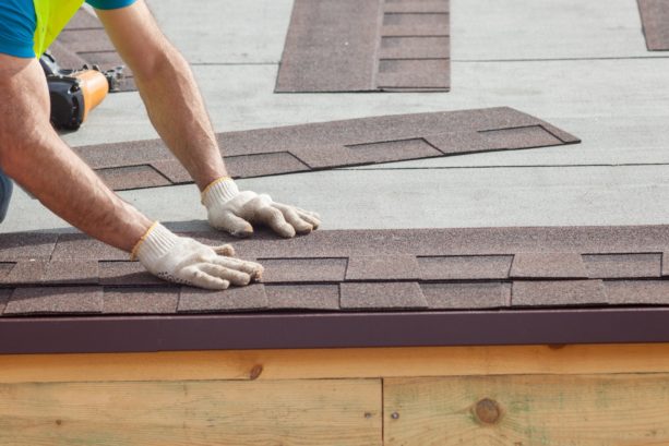 covering the sheathed roof with shingles