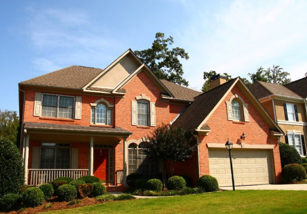 an orange brick house with white shutters