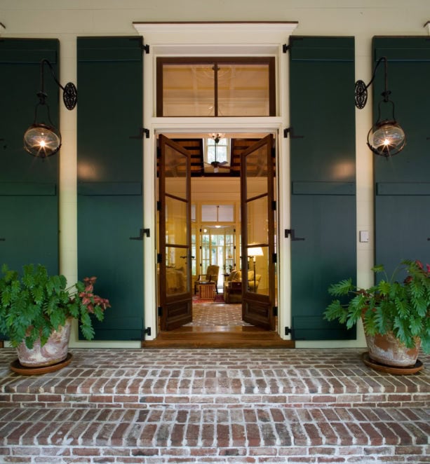 a tall traditional entry with large transom and simple trim that comes with crown