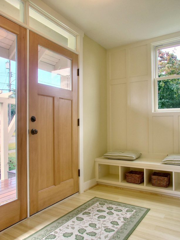 a traditional front door with single sidelight and simple transom window above it