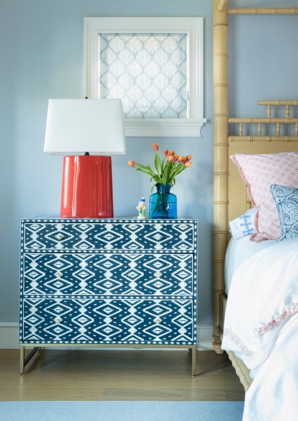a unique bedside table with coral lamp on it