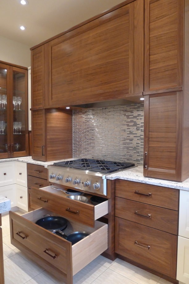 metallic backsplash behind stove combined with granite countertops