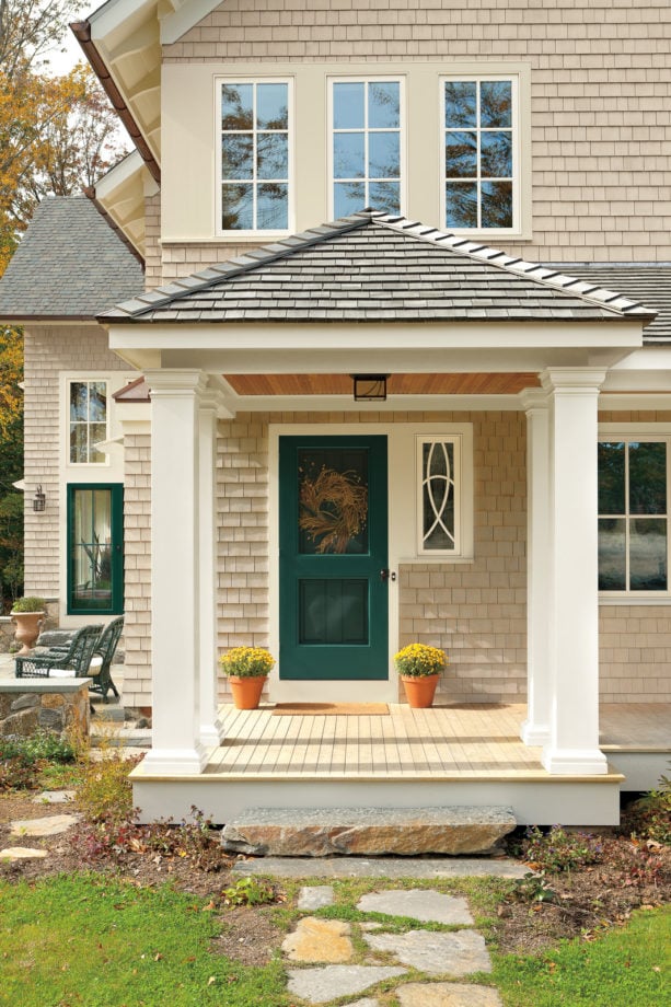 a traditional front door trim united with the window trim next to it
