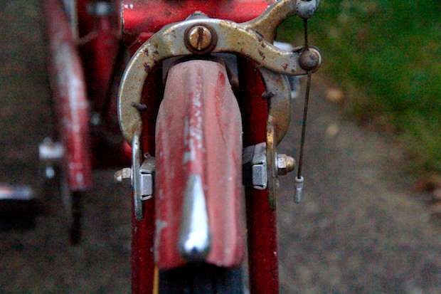 Caliper brakes on a very old red bike