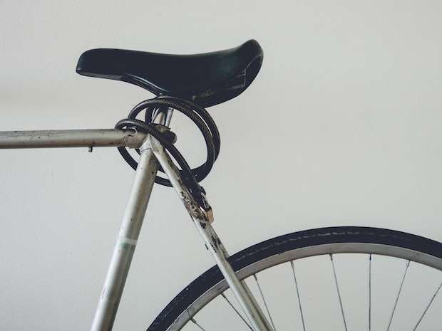 Cable lock wrapped around a bicycle seat post