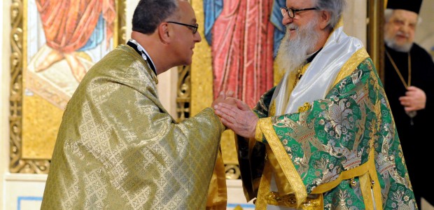 Father Anastasios Gounaris (L), the embattled Dean of Holy Trinity Cathedral in Manhattan, receives a blessing from Archbishop Demetrios as Bishop Philotheos of Meloa looks on.