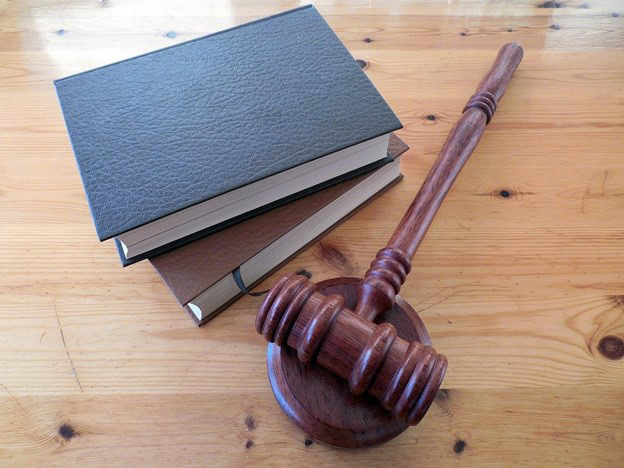 A mallet beside two law books