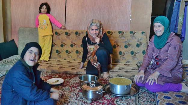 Nour, a widowed Syrian refugee caring for three children including a son with Down's syndrome, relies on the pots of hearty soups and stews as her family's only hot meals three times a week. The menu of traditional Syrian dishes prepared by the community kitchen is overseen by IOCC nutrition experts to ensure that the meals are providing a balanced diet to the refugees. photo: Ryan Erickson/IOCC
