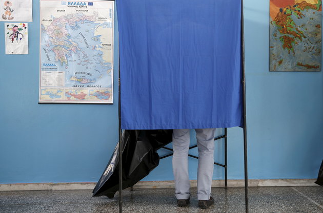 A voter is seen in polling station in Athens