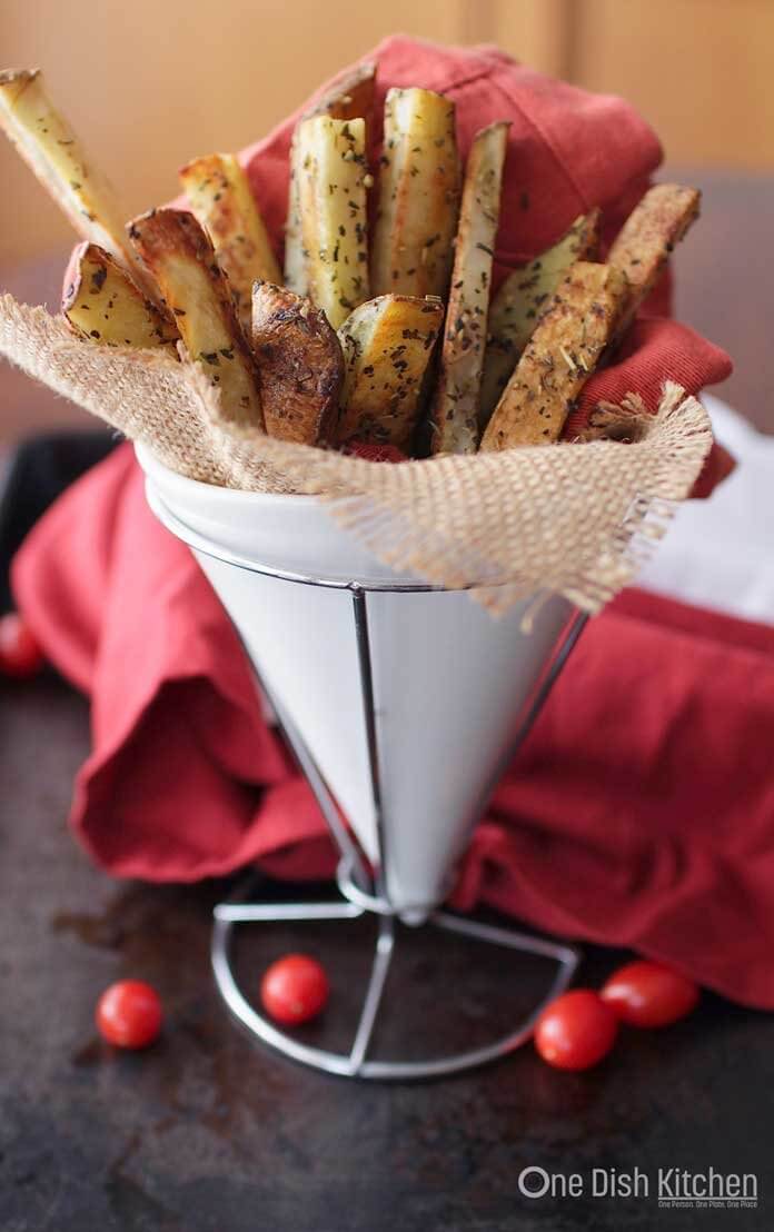 Thick cut homemade baked french fries recipe made with 1 russet potato and baked in the oven. This small batch recipe yields the perfect amount of french fries for one person. They're crispy on the outside, creamy on the inside and perfect for dipping in your favorite sauce. | One Dish Kitchen
