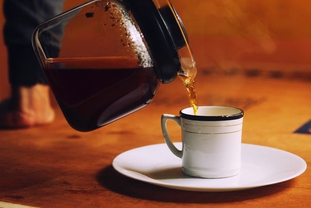 Pouring Hot Tea Into White Cup and Saucer Pouring Hot Tea Into White Cup and Saucer