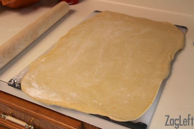 Dough rolled out on a large cutting board